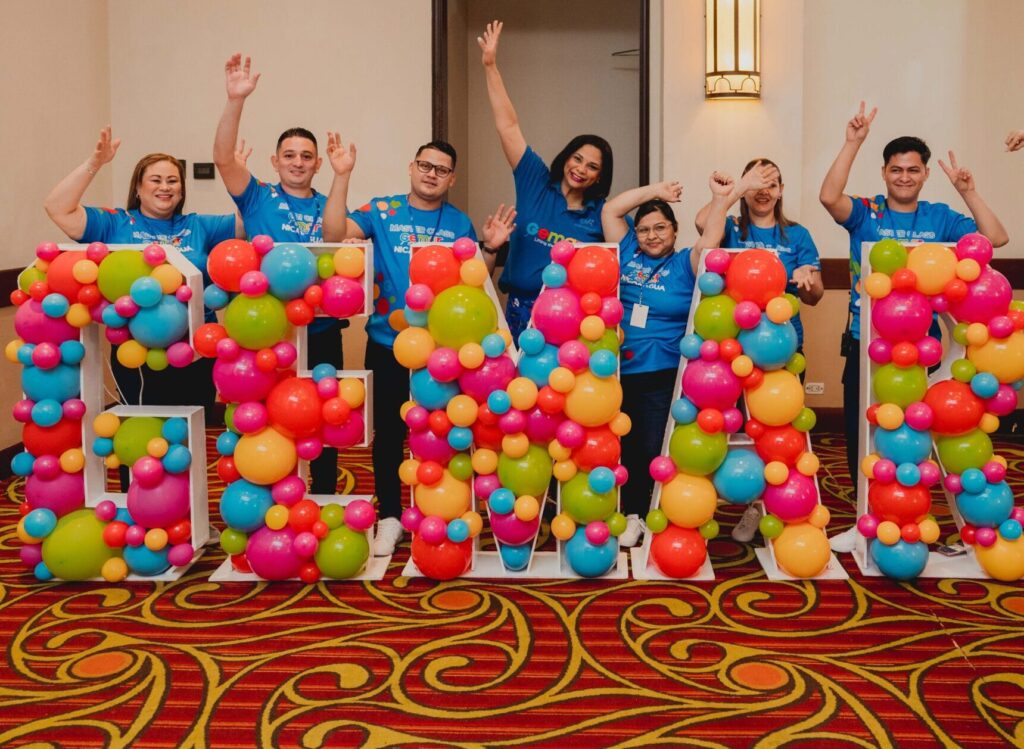 Balloon artists creating colorful installations at Gemar USA sponsored event