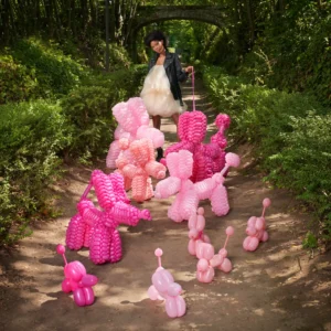 Giant pink balloon poodles art installation, whimsical balloon animals for outdoor event decoration