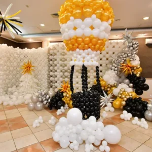 Gold and white hot air balloon sculpture with black and silver details, elegant balloon installation for luxury indoor events.