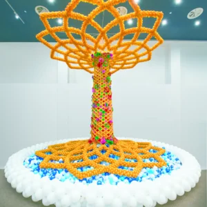 Golden balloon tree sculpture with colorful details, large balloon installation for luxury events