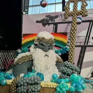 Grey and gold balloon sculpture of Poseidon with trident, creative large-scale balloon art for themed events