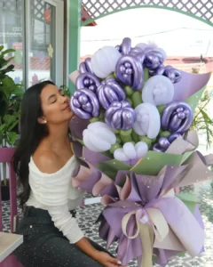 Woman with shiny purple balloon flower bouquet for celebration gift