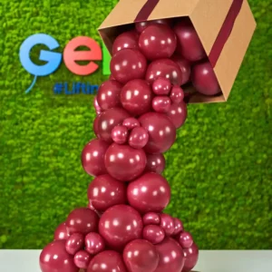 Vino balloon box installation with cascading balloons, creative event decor display