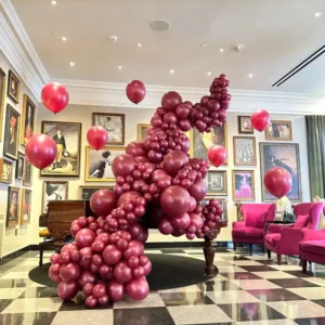 Vino balloon garland installation for luxury indoor event, elegant organic balloon decoration