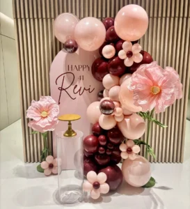 vino organic balloon arrangement with floral accents, styled for an elegant birthday celebration.